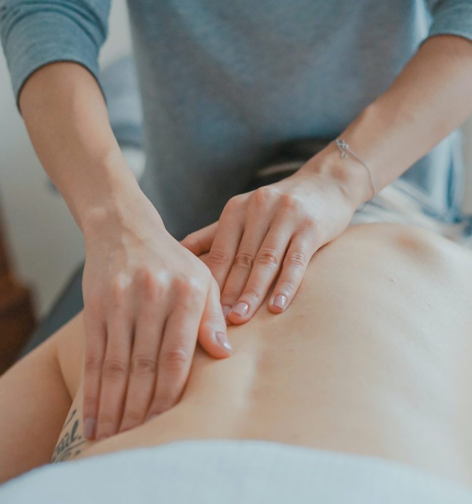 Registered massage therapist treating a client's lower back